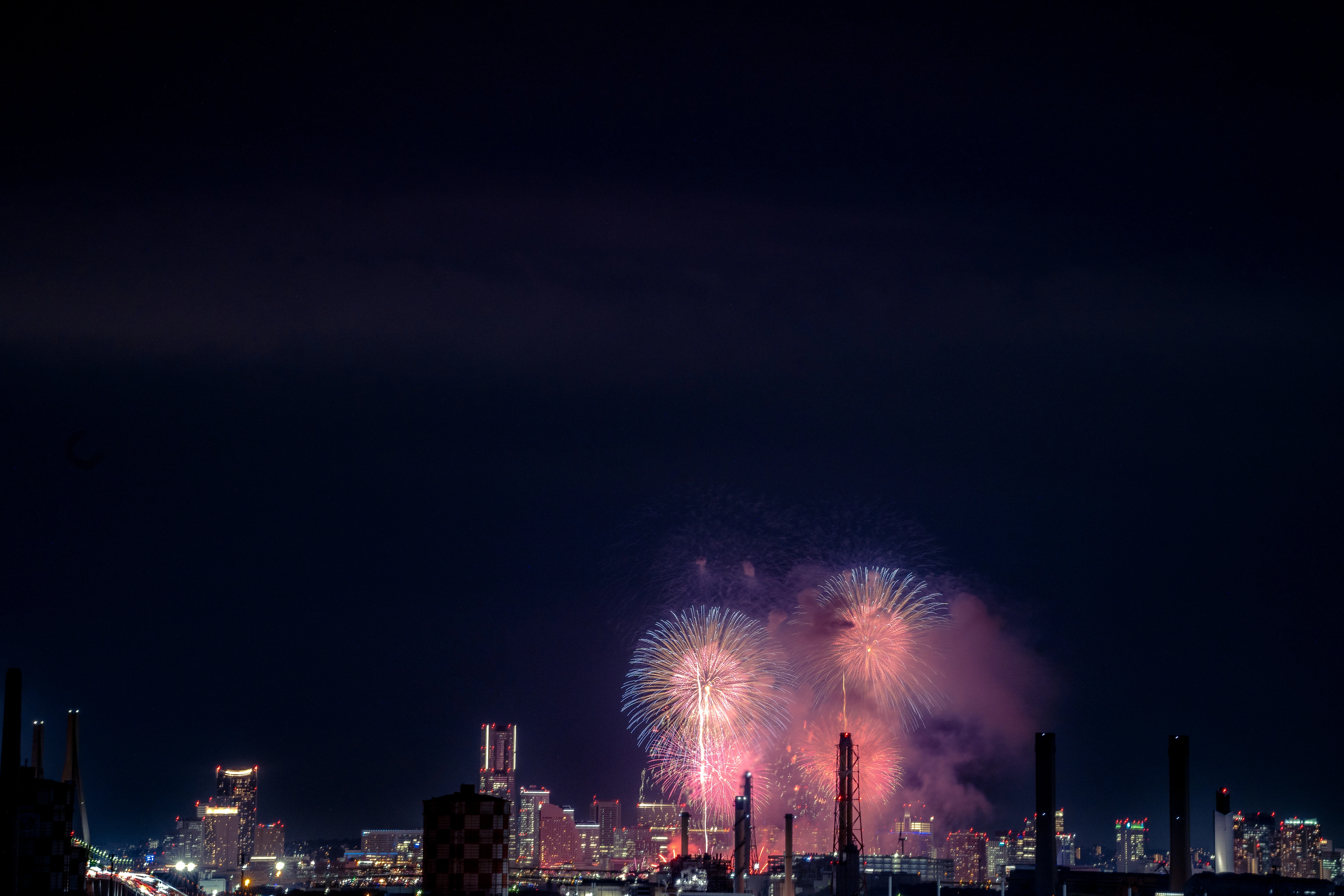 Vibrant Fireworks Illuminating City Nightscape